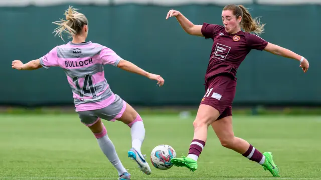 Partick Thistle's Amy Bulloch and Hearts' Kathleen McGovern challenge for the ball