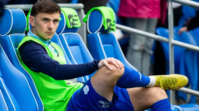 Mark Harris sits on the bench as a substitute for Cardiff City