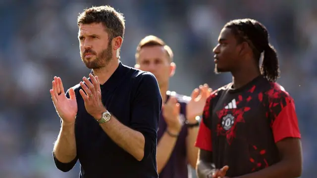 Michael Carrick, Manager of Manchester United, applauds the fans.