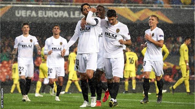 Valencia's players celebrate scoring against Villarreal in the Europa League