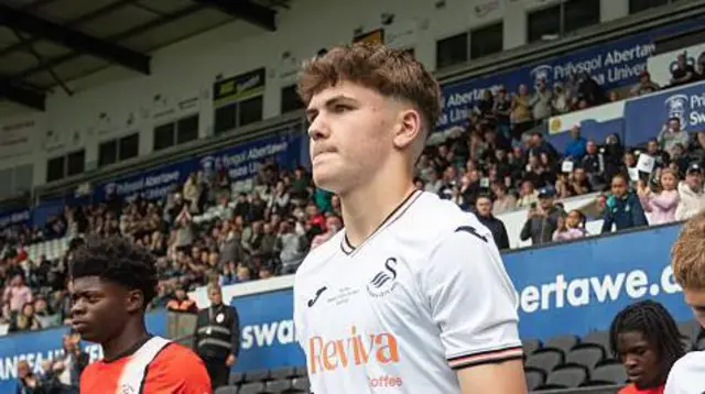 Swansea youngster Carter Heywood leads out the club's under-17 side last year 