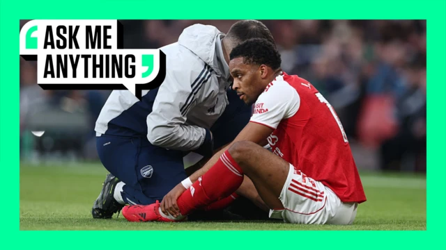 Jurrien Timber sitting injured on the pitch receiving treatment. The image is surrounded by a green border with 'Ask Me Anything' in the top corner