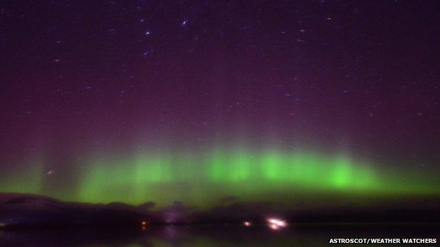 Green glow of the Northern Lights in the night sky