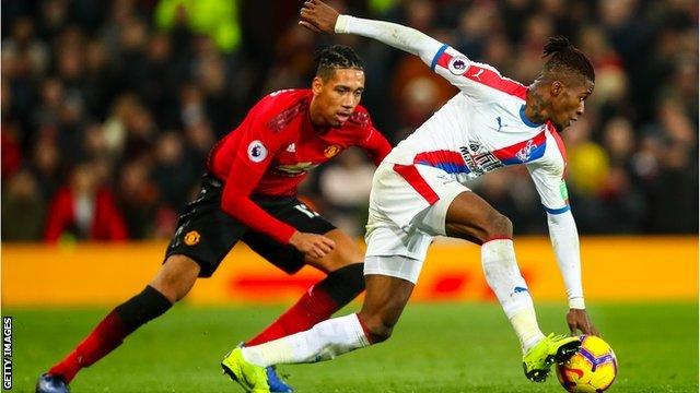 Wilfried Zaha (right) in action against Manchester United