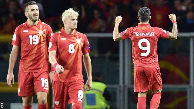 Macedonia's players celebrate scoring against Italy