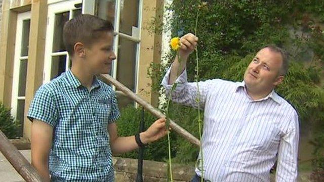 Darren Millar and son Toby with giant dandelion