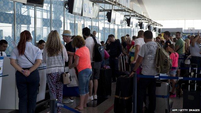 British tourists queue up at the Enfidha International airport as they leave Tunisia