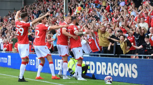 Wrexham players celebrate the goal of Steven Fletcher against Wycombe Wanderers with the home fans