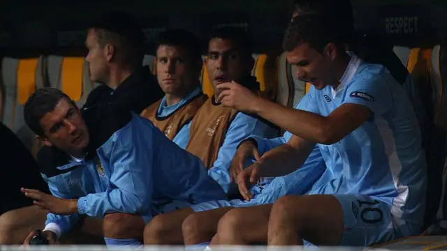 Edin Dzeko reacts after his substitution with Tevez in the background