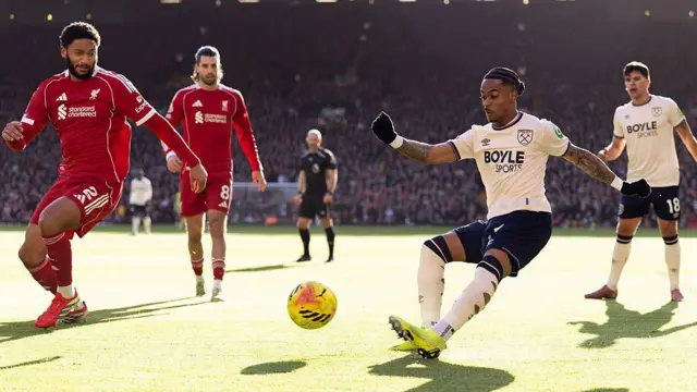 West Ham play Liverpool. Summerville crosses with Joe Gomez close to him.