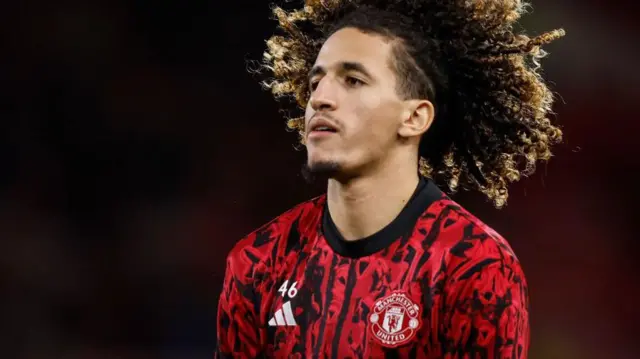 Hannibal Mejbri warms up before a Manchester United match