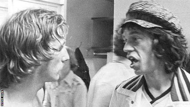 Steve Hunt and Mick Jagger chat in the dressing room after a New York Cosmos game