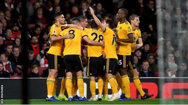 Wolves players celebrate scoring against Arsenal