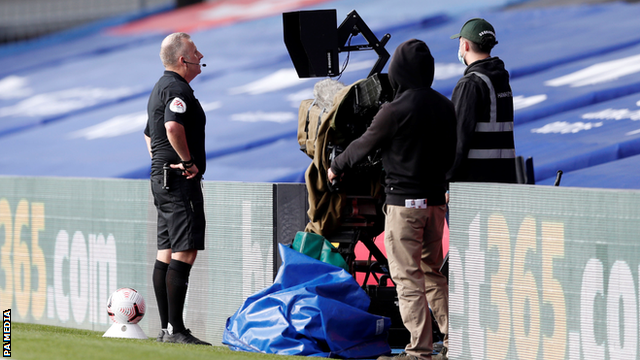 Referee Jonathan Moss reviews an incident on the pitch-side monitor during Crystal Palace's home game with Southampton