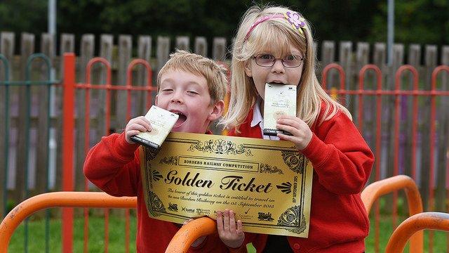 Golden Ticket promotion at Tweedbank Primary School. Angus Parker and Emily MacClure hold bars of Cocoa Black chocolate and a giant Golden Ticket.