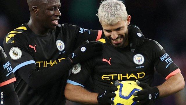 Sergio Aguero (right) clutches the match ball after scoring a hat-trick for Manchester City at Aston Villa