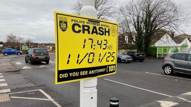 A yellow Hampshire & Isle of Wight constabulary sign on a lamppost in the car park at Asda on Dock Road 