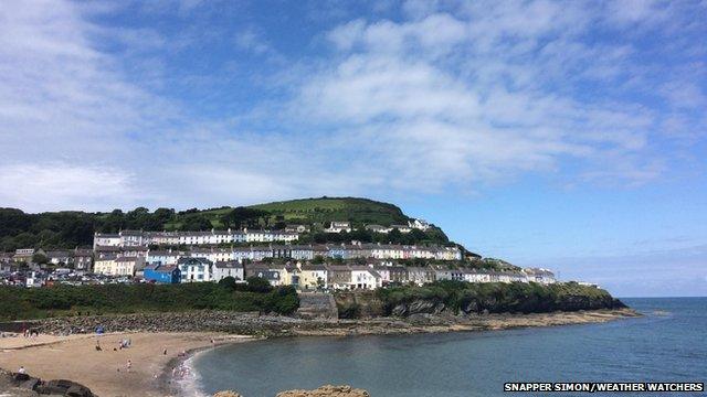Wide shot of a seaside resort on a bright but cloudy day