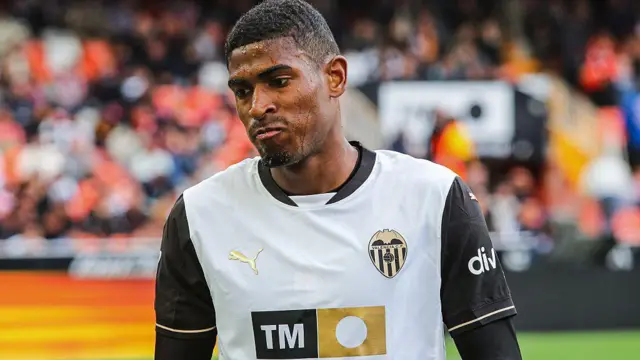Cristhian Mosquera wearing a white Valencia shirt