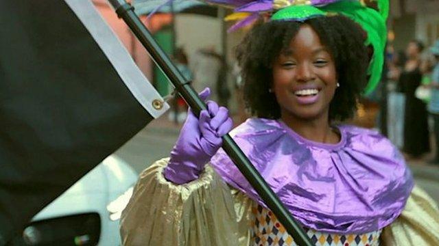 A young black woman dancing in a parade