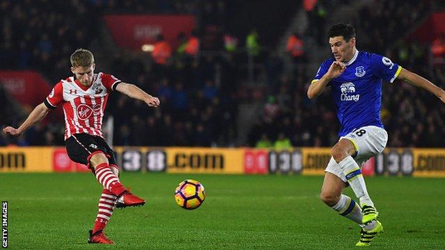 Southampton's 19-year-old debutant Josh Sims (left) has a shot against Everton