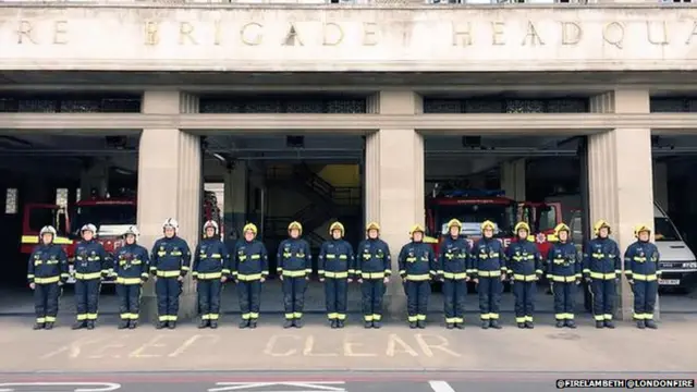 Firefighters holding a minute's silence