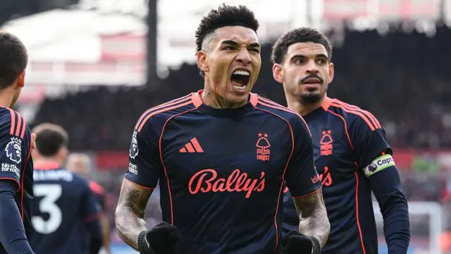 Igor Jesus holds up his arms and shouts to celebrate scoring a goal