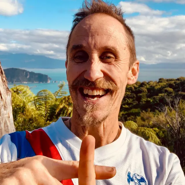 Crystal Palace fan stood in front of a scenic coastline