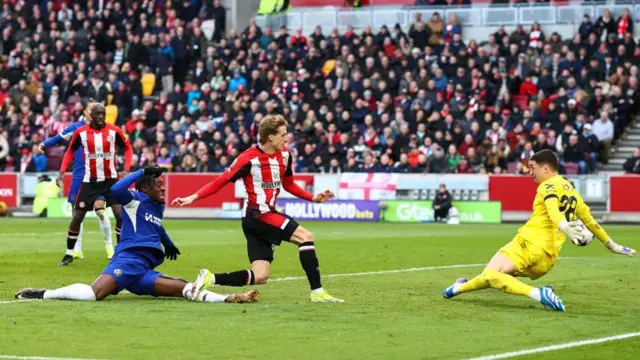 Mads Roerslev of Brentford scores their first goal during the Premier League match between Brentford FC and Chelsea FC at Brentford Community Stadium on March 2, 2024.