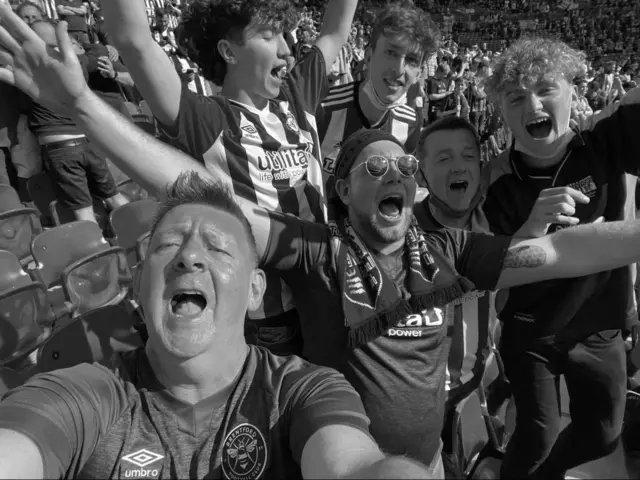 Black and white showing Christy and fellow Brentford fans