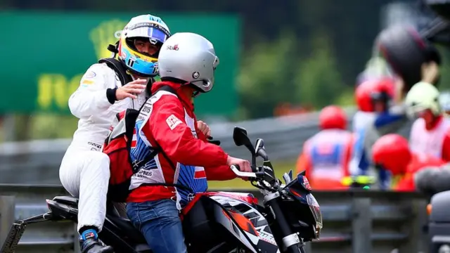 Fernando Alonso hitches a ride back to the pits