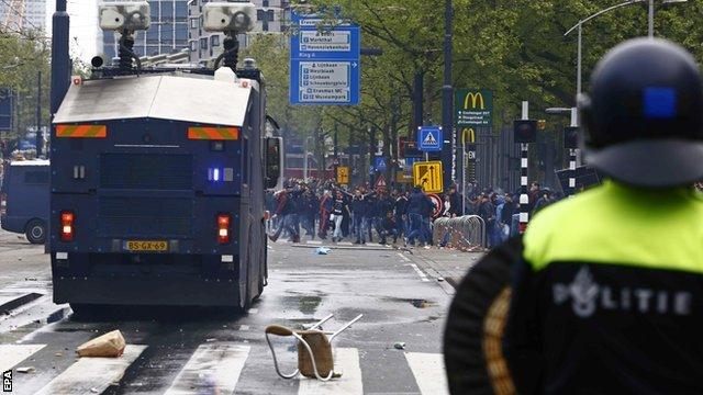 Riot police used water cannon to disperse fans after the Rotterdam derby