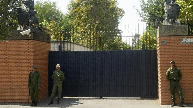 Iranian soldier stands guard in front of the main gate of the British embassy in 2003