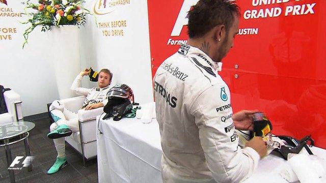 Nico Rosberg throws his podium cap at Lewis Hamilton