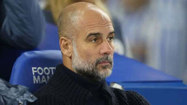 Pep Guardiola looks on dejectedly