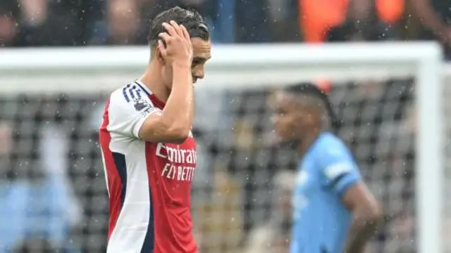 Leandro Trossard leaves the pitch following his red card