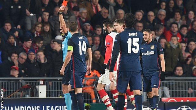 Uruguay-born PSV Eindhoven forward Gaston Pereiro is shown a red card for jumping into countryman Diego Godin