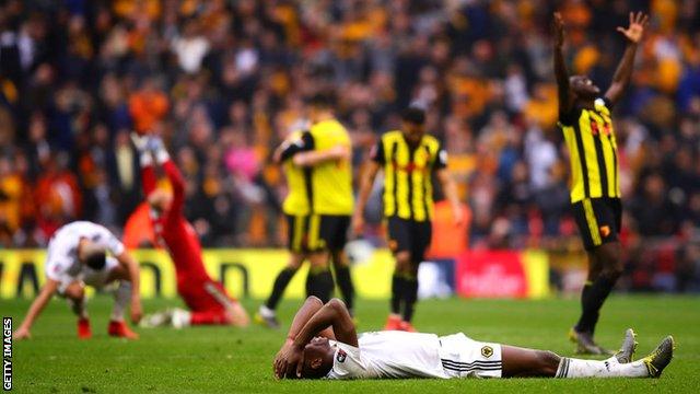 Wolves players falling to the ground at full-time