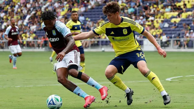 Aston Villa midfielder Leon Bailey #31 makes a move in front of Nashville SC midfielder Matthew Corcoran