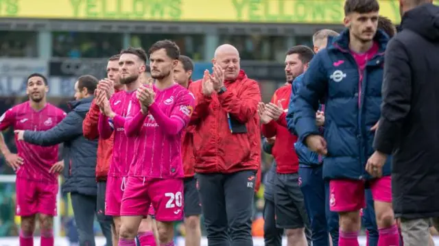 Swansea players applaud their fans a6fter the draw at Norwich