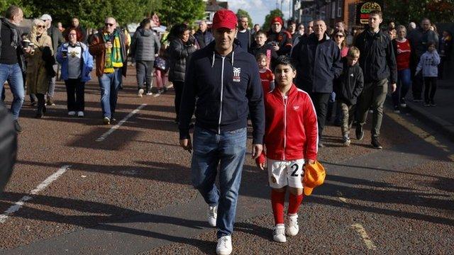 boy walking to match with dad