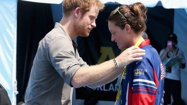 Prince Harry presents USA Invictus Team Member Elizabeth Marks with a Gold Medal