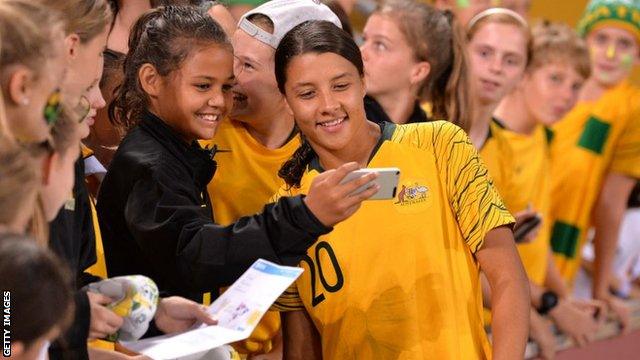 Australia's Sam Kerr poses for a selfie with a fan