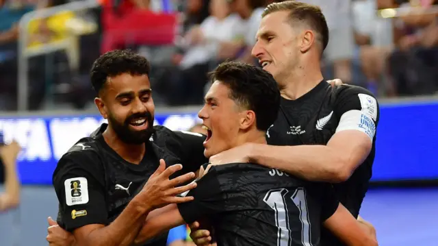 New Zealand's Elijah Just (centre) celebrates scoring their first goal with Sarpreet Singh and Chris Wood 