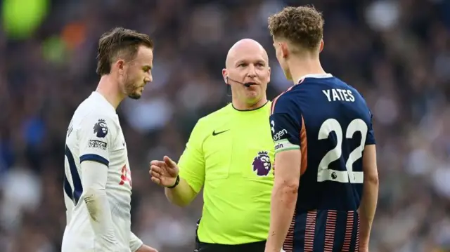 The referee speaks to James Maddison and Ryan Yates