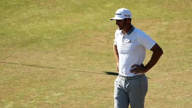 Dustin Johnson waits on the green