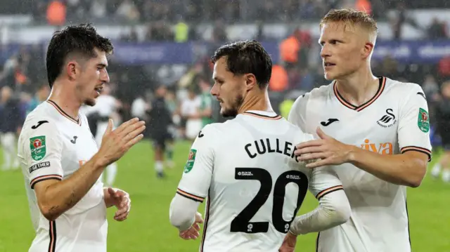 Josh Key, Liam Cullen and Kristian Pedersen celebrate Swansea's win over Gillingham 