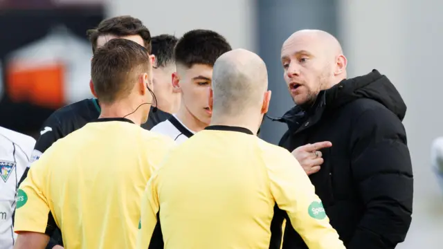 Hibernian head coach David Gray voices his frustrations to the team of officials at East End Park.