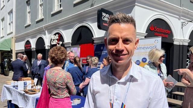 Dr in front of pop-up stand in St Helier 