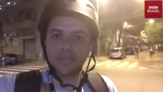 Felipe Souza on what looks like a phone camera, in the street wearing a helmet